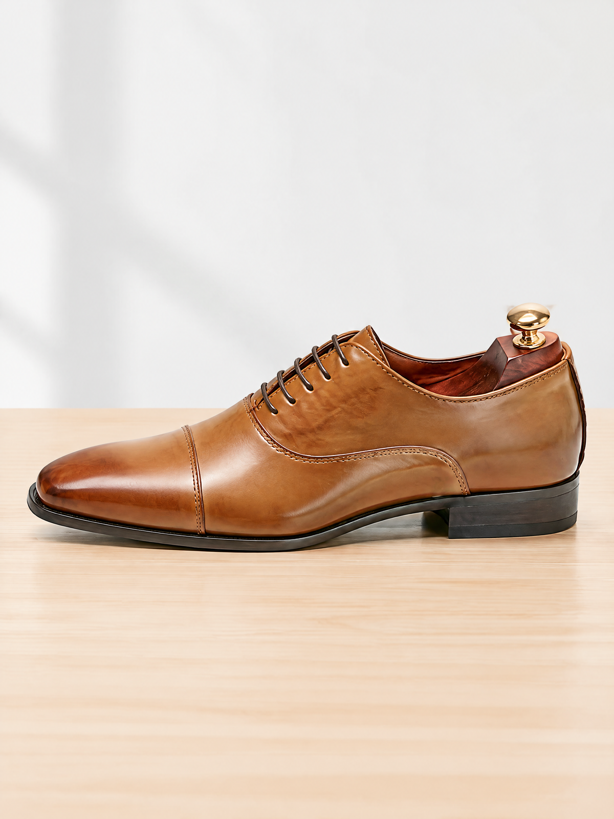 Savile men's burnished brown leather cap toe oxford shoes on dark reflective background