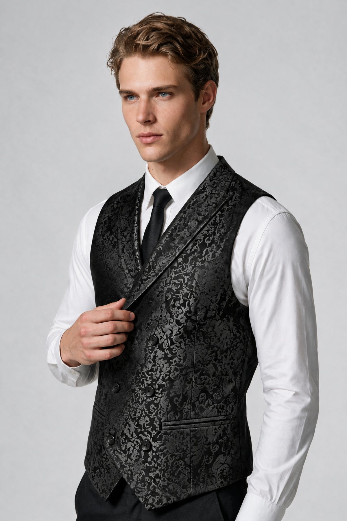 Close-up front view of Savile black paisley jacquard vest with peak lapel, adjusting collar