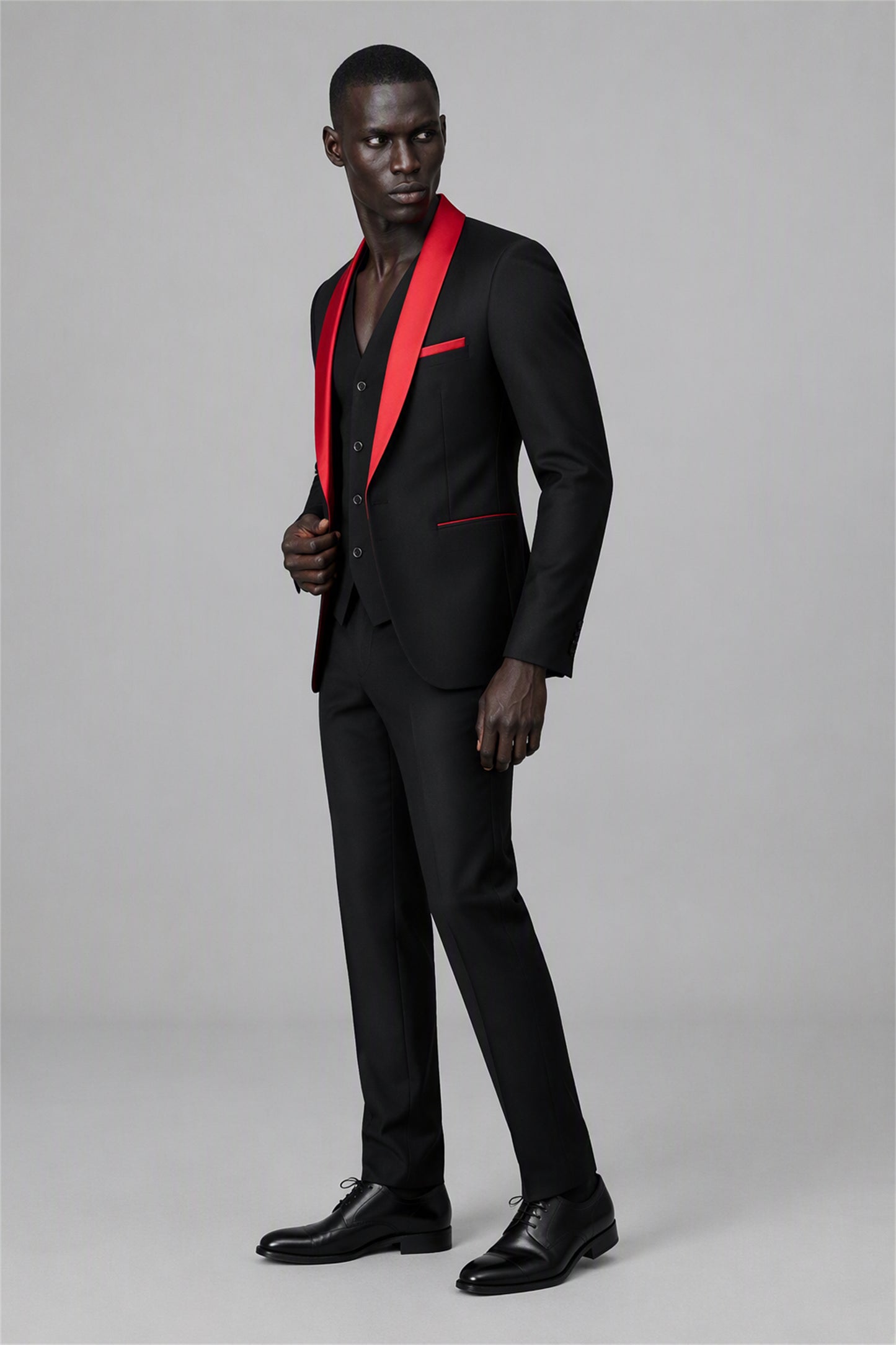 Savile Black & Red 3-Piece Tuxedo Set – Full side profile view showing slim silhouette, red satin shawl lapel edge, red pocket trim and tapered black trouser fit