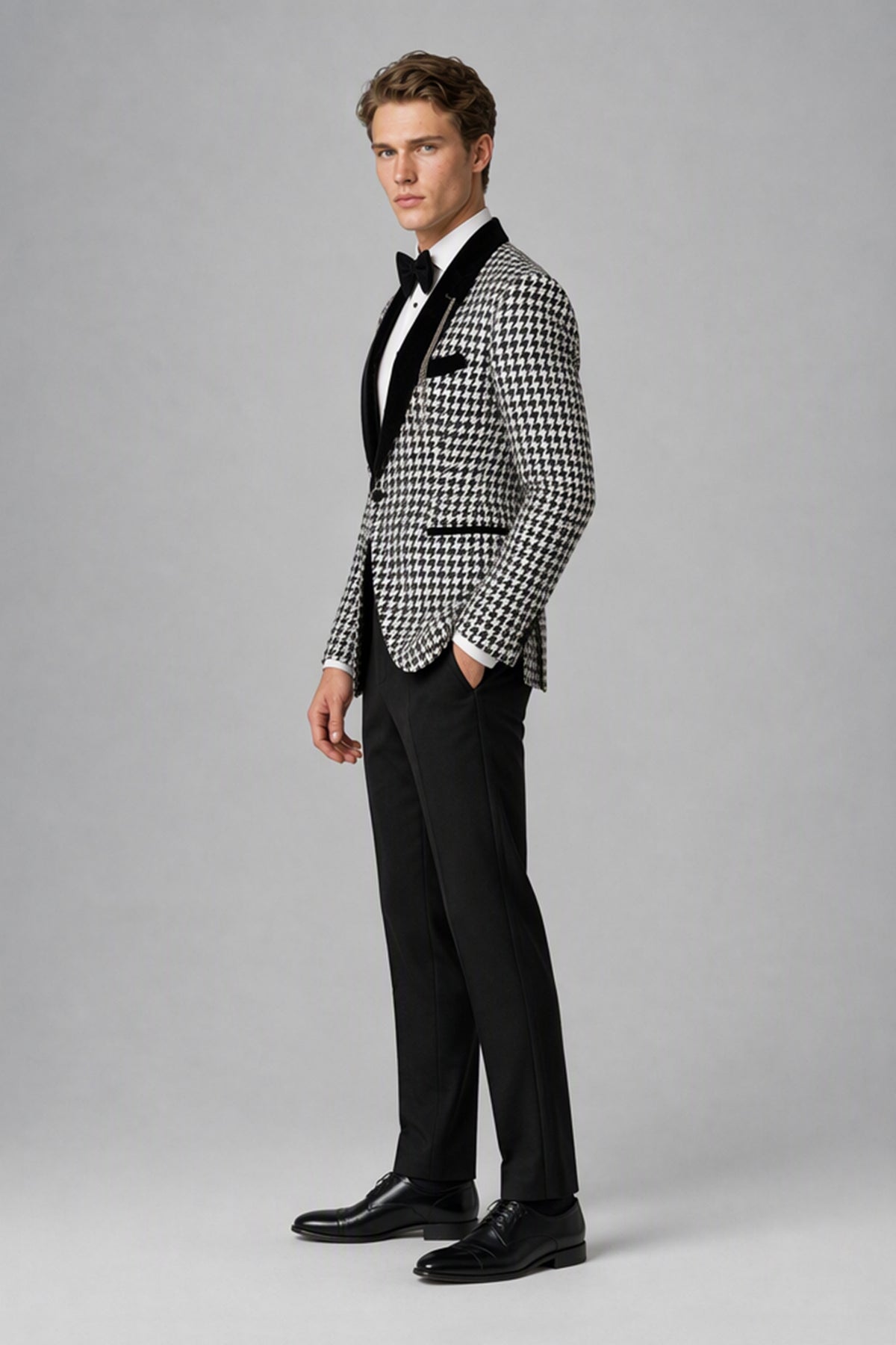 Man wearing Savile houndstooth tuxedo suit, front view with arms crossed