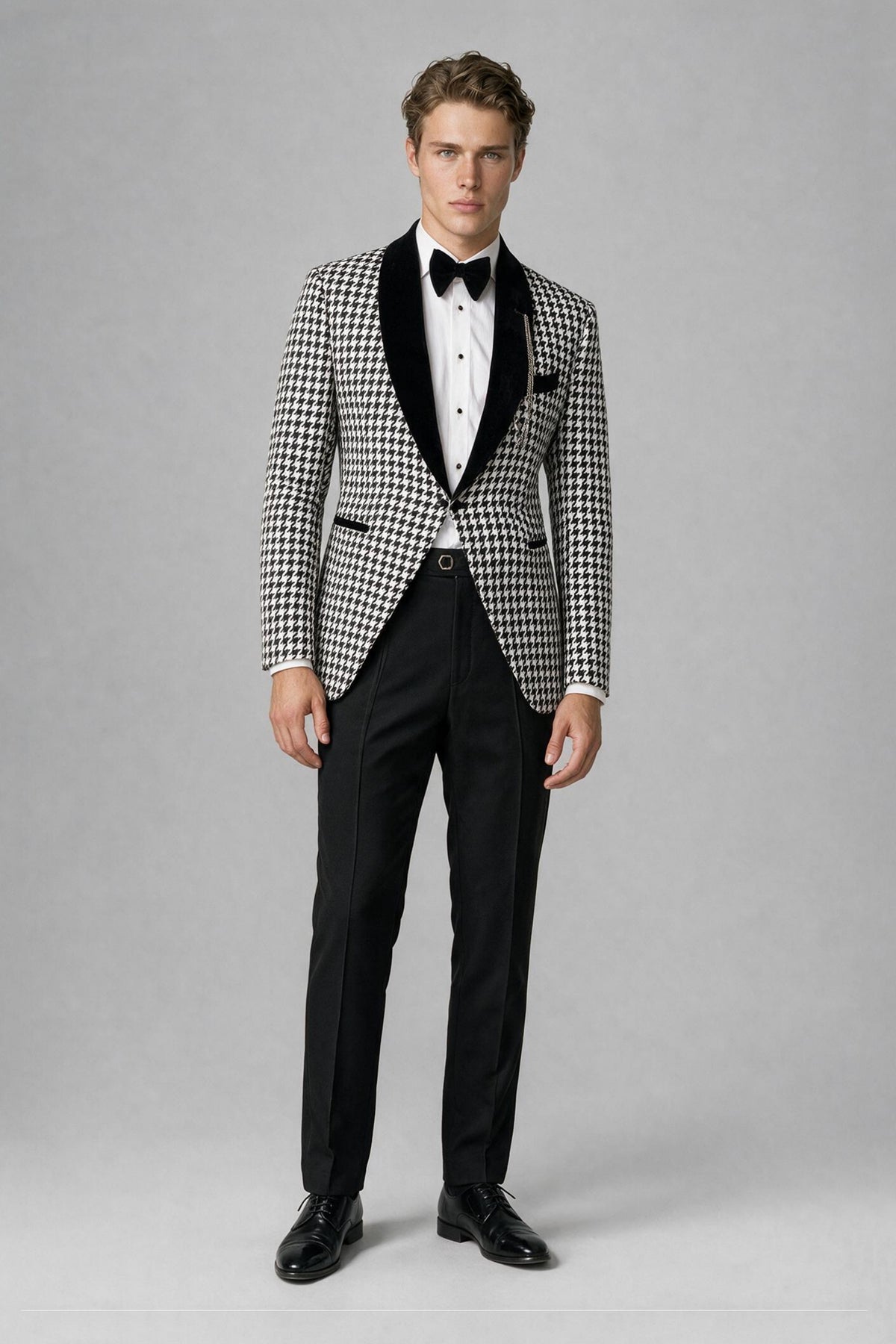 Man wearing Savile black and white houndstooth 2-piece tuxedo suit with velvet lapel, front view