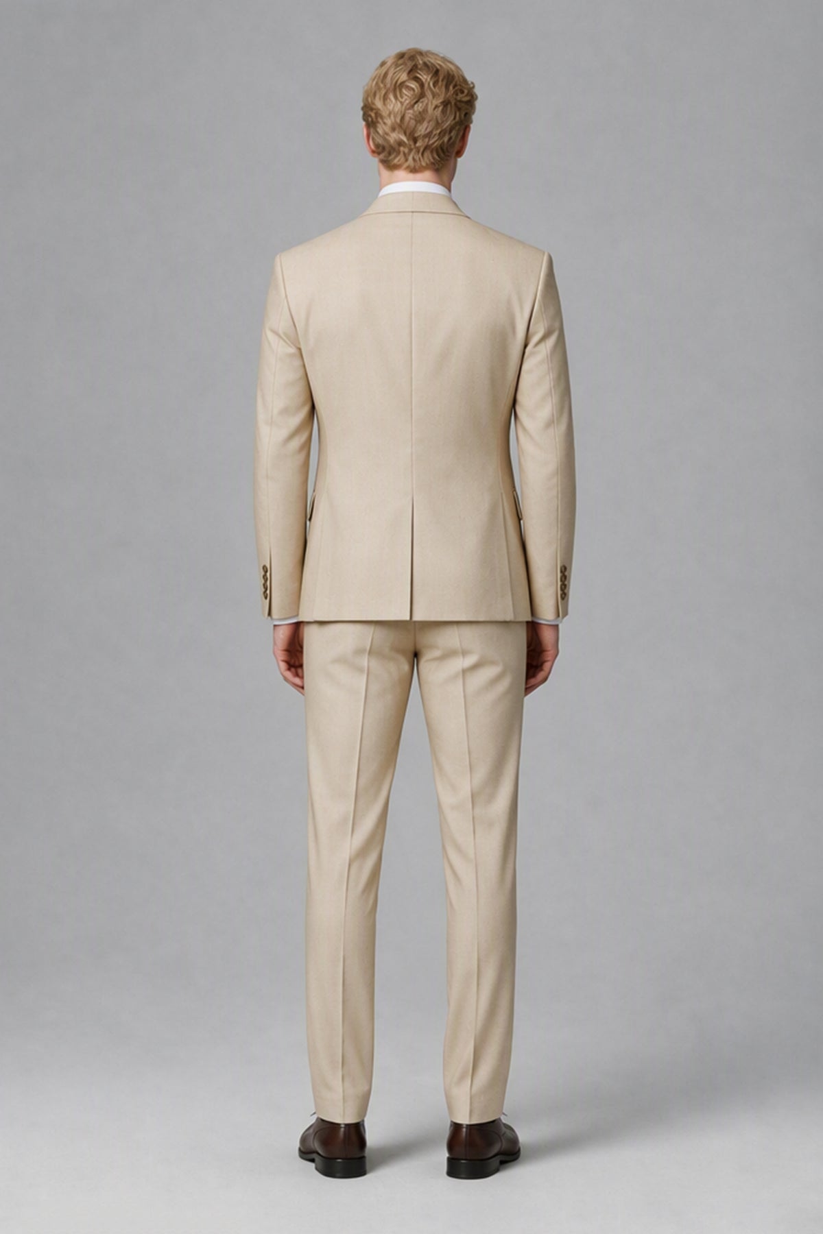 Angled full-length view of Savile beige three-piece wedding suit
