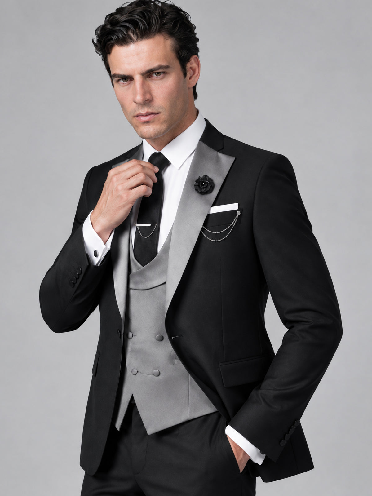 Savile Men's Black Tuxedo Close-Up View of Contrast Silver Peak Lapel, Double-Breasted Grey Vest, and Black Tie