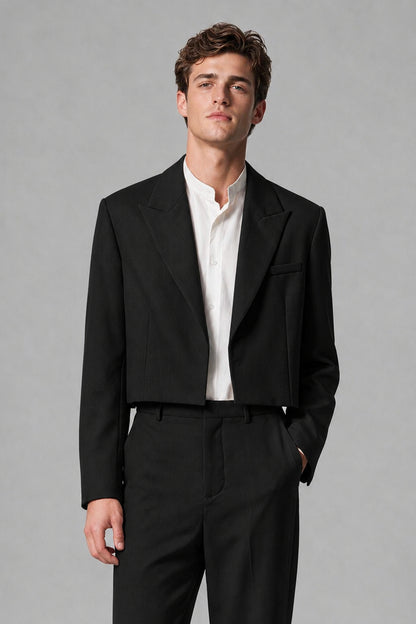 Close-up front view of the Savile cropped black peak-lapel blazer with long sleeves and welt chest pocket