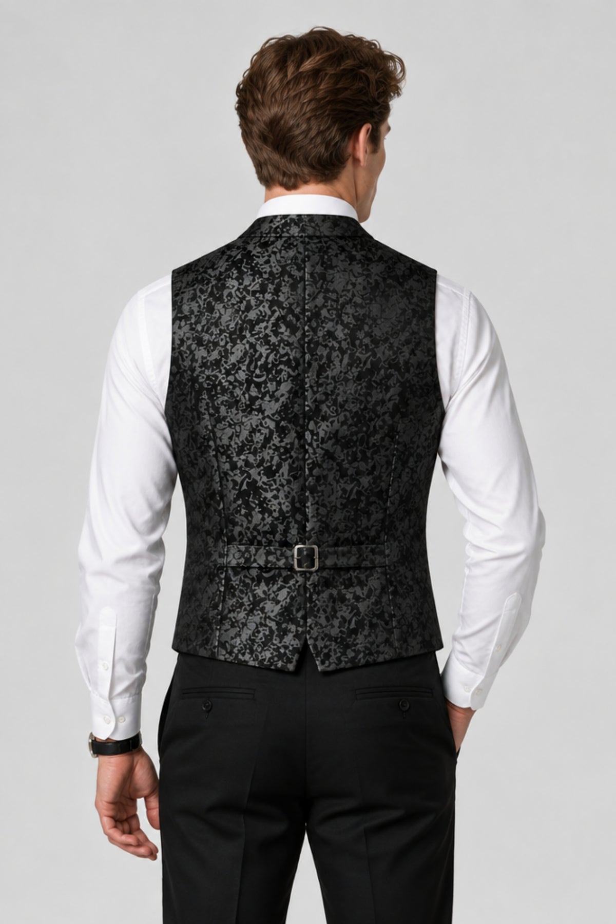 Man wearing Savile black paisley jacquard vest, back view showing adjustable strap