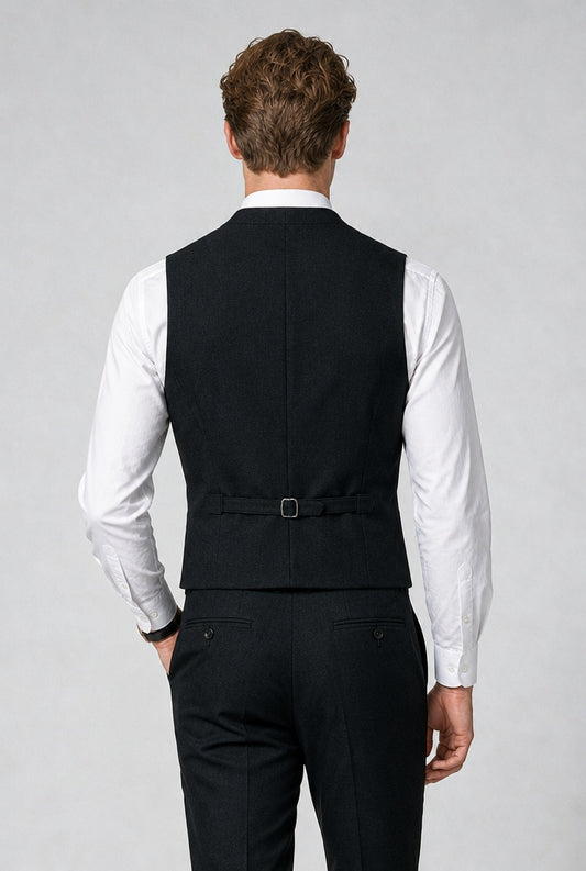 Model walking wearing Savile black double-breasted shawl lapel vest with white shirt and tie