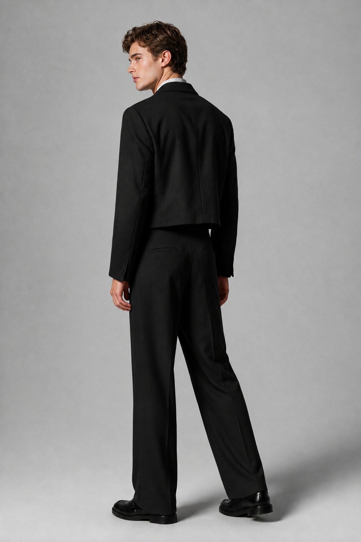 Back view of the Savile black cropped jacket and wide-leg trousers two-piece suit