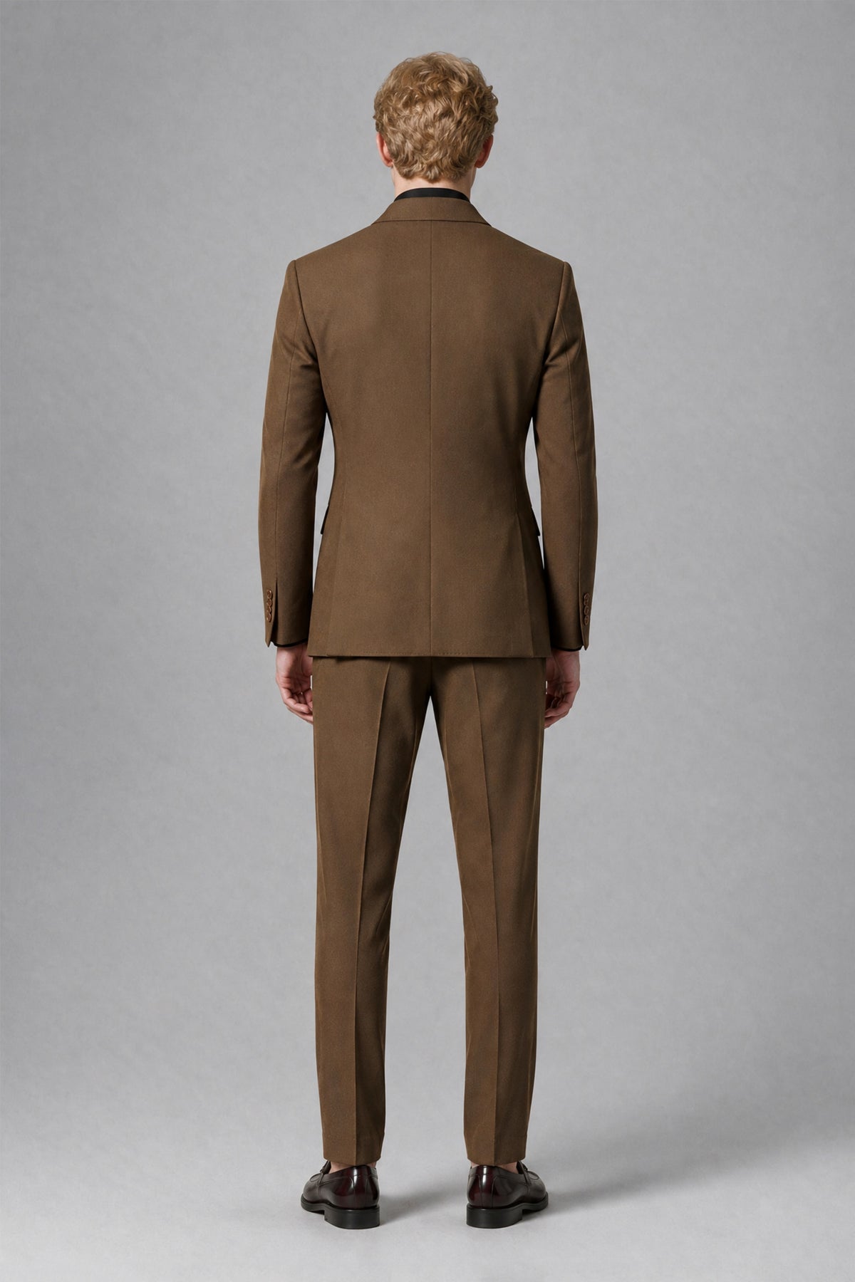 Styled front full-length view of brown jacket and matching trousers
