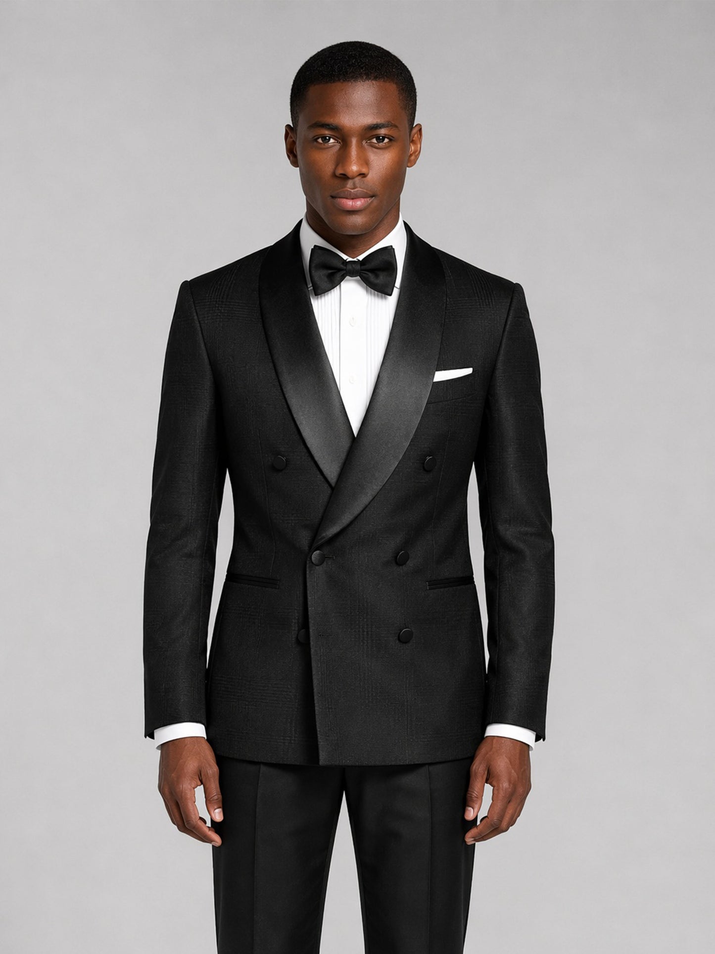 Men's black tuxedo suit - three-quarter front view with hand on jacket showing fit