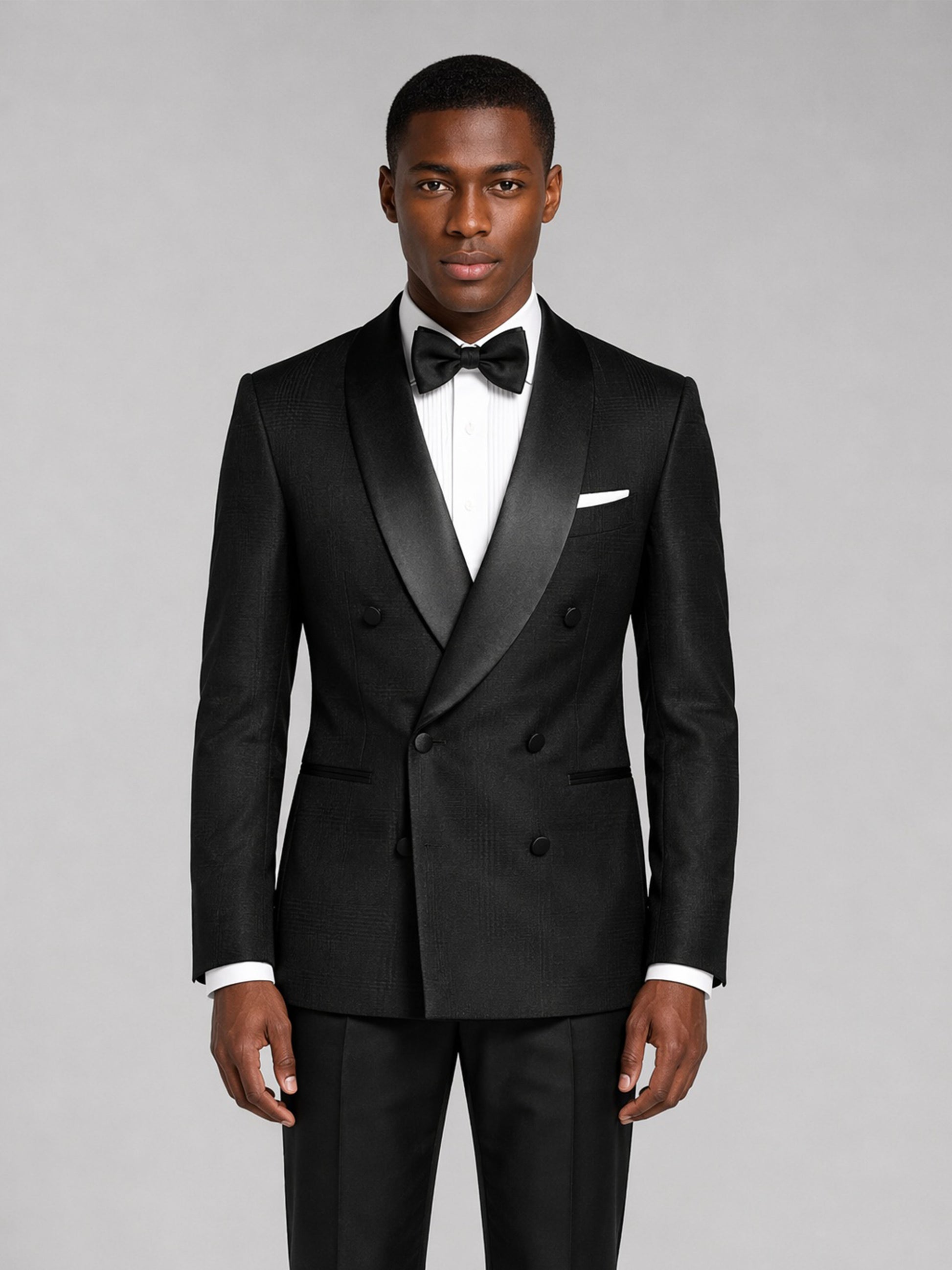Men's black tuxedo suit - three-quarter front view with hand on jacket showing fit