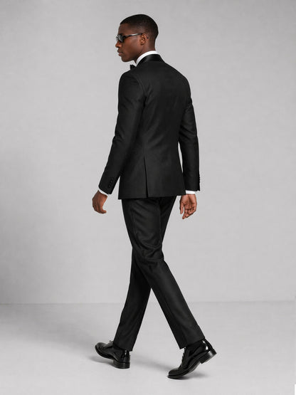 Men's black tuxedo suit - back view walking pose showing jacket cut and trouser length