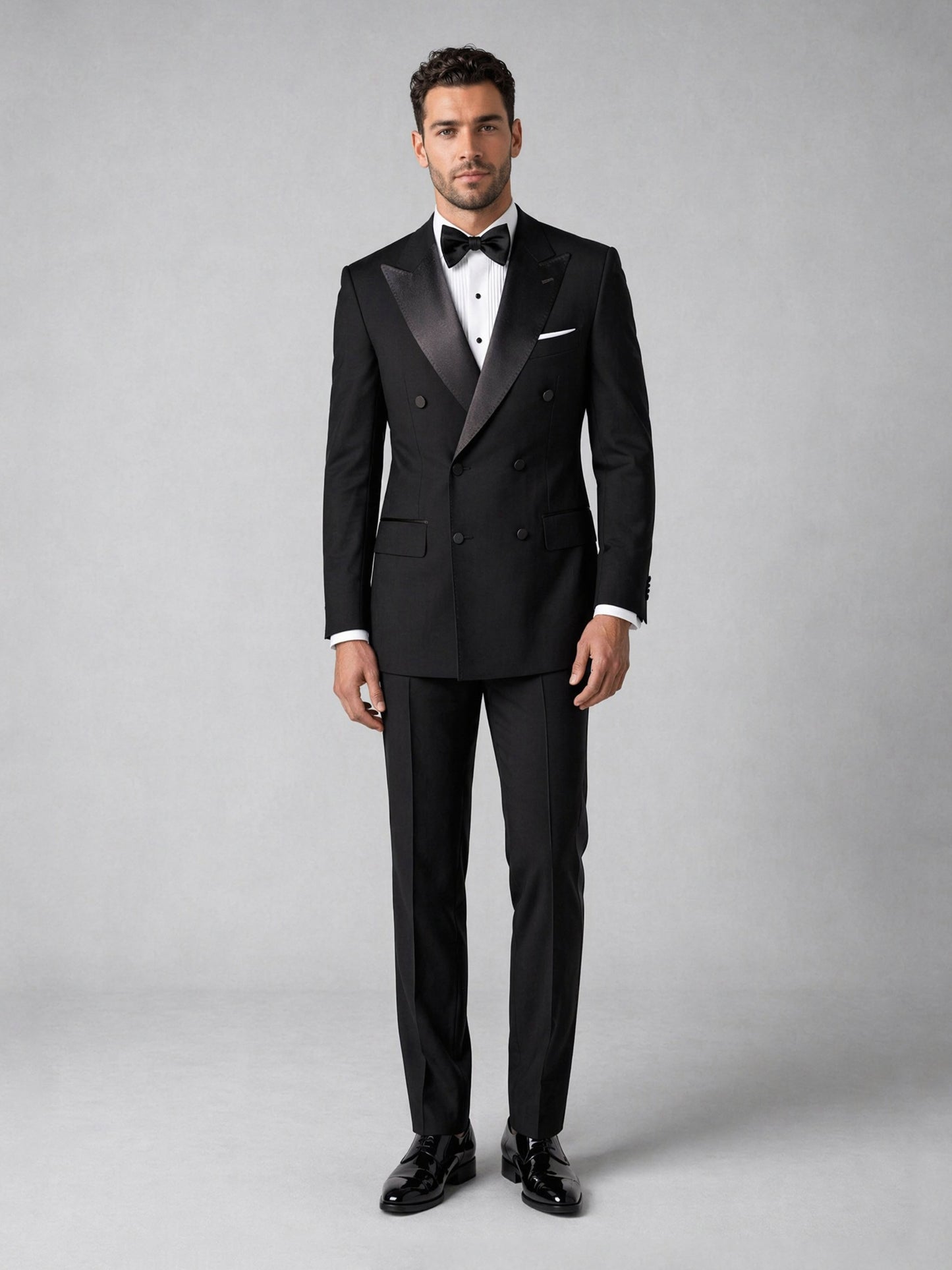Men's black tuxedo suit - upper body side view hand on waist showing jacket structure