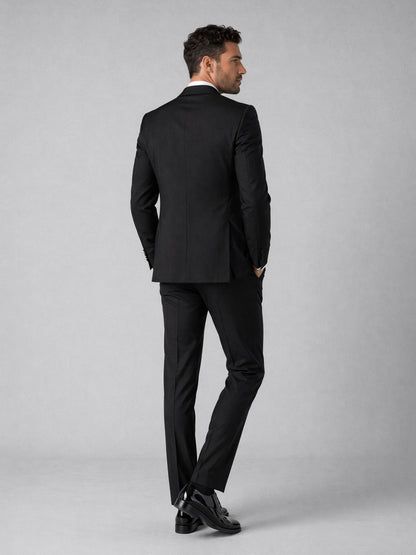 Men's black tuxedo suit - back view showing jacket cut and full-length trouser finish
