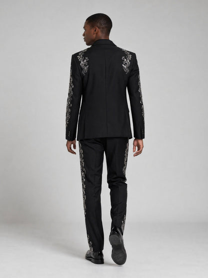 Men's black embroidered suit - full length contemplative pose showing slim fit silhouette