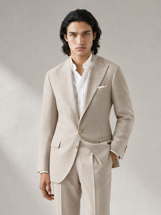 Savile GA0063 oatmeal linen suit set – three-quarter side pose, model adjusting collar showing relaxed Italian drape