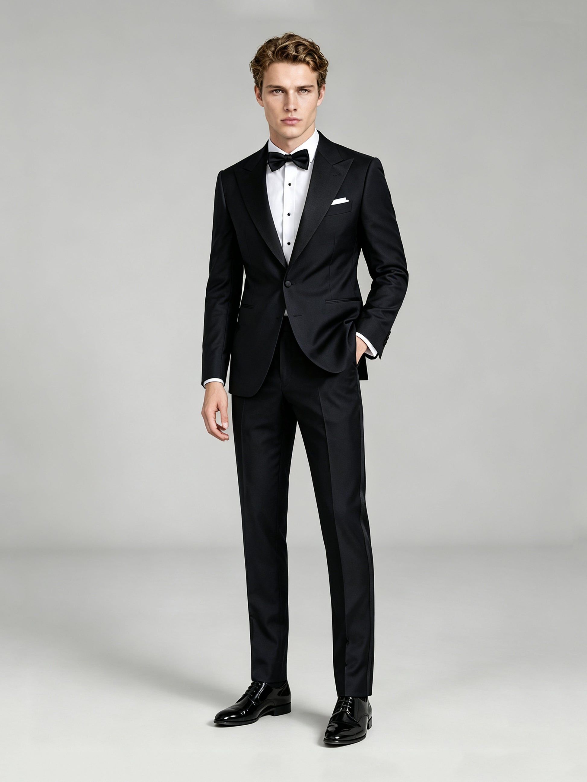Savile GA0065 black peak lapel tuxedo – upper body front view showing satin peak lapel, pleated tuxedo shirt, black bow tie and white pocket square