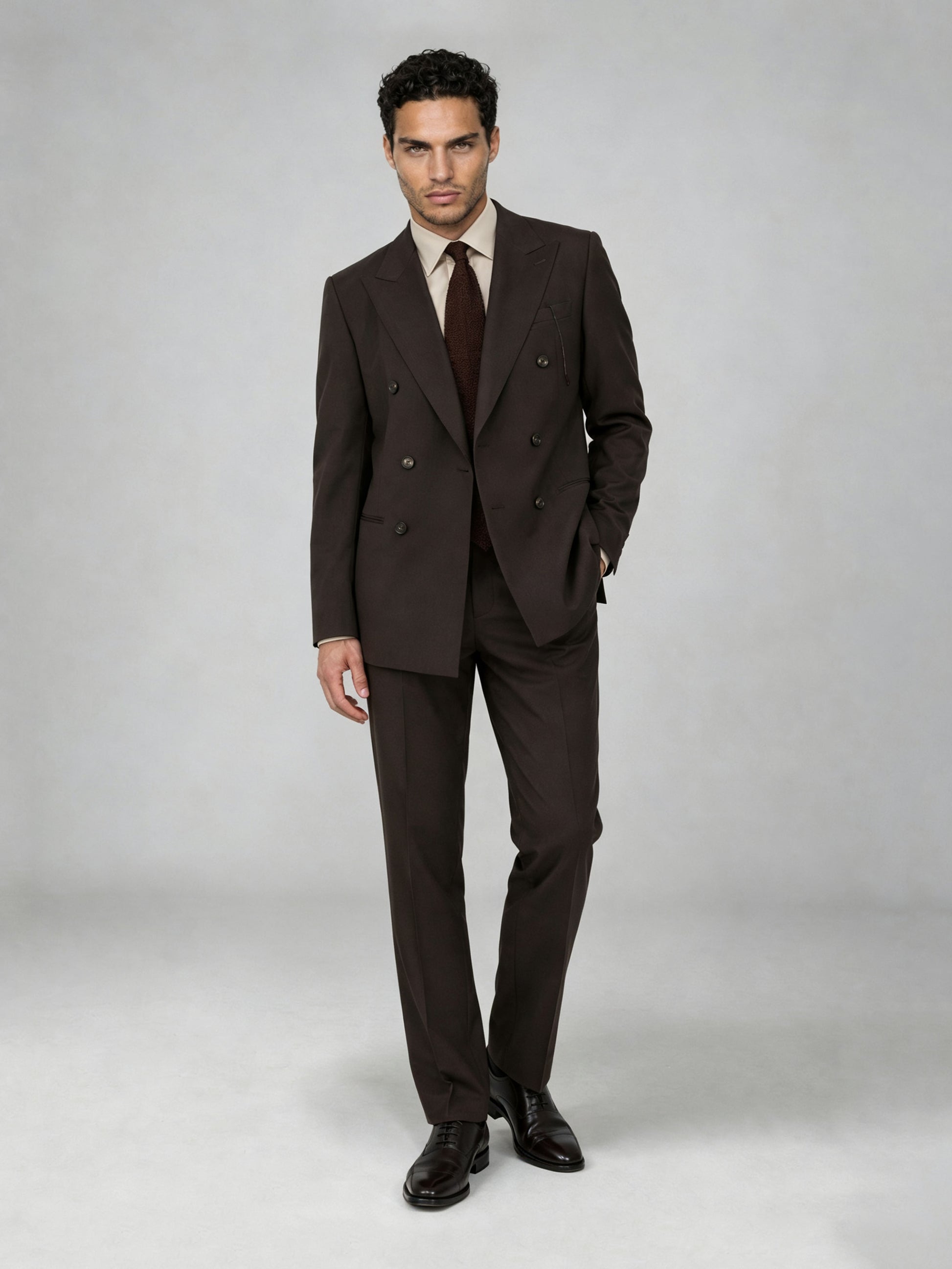 Savile GA0068 espresso brown double-breasted suit – upper body front view showing peak lapel, six-button closure, cream open-collar shirt and brown knit tie