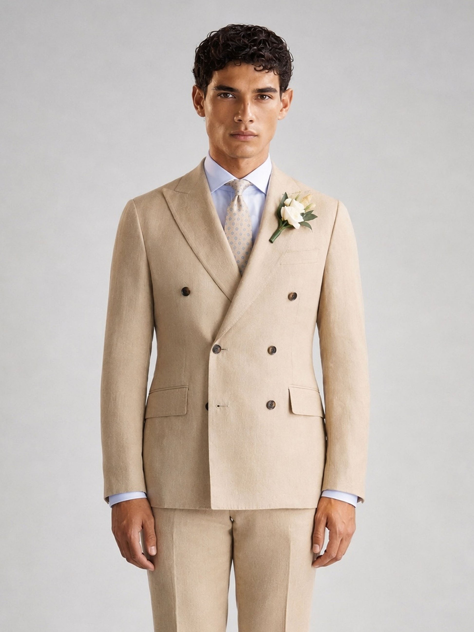 Savile GA0071 sand camel linen double-breasted suit – full body front view, hand in pocket showing relaxed confidence and warm-weather elegance