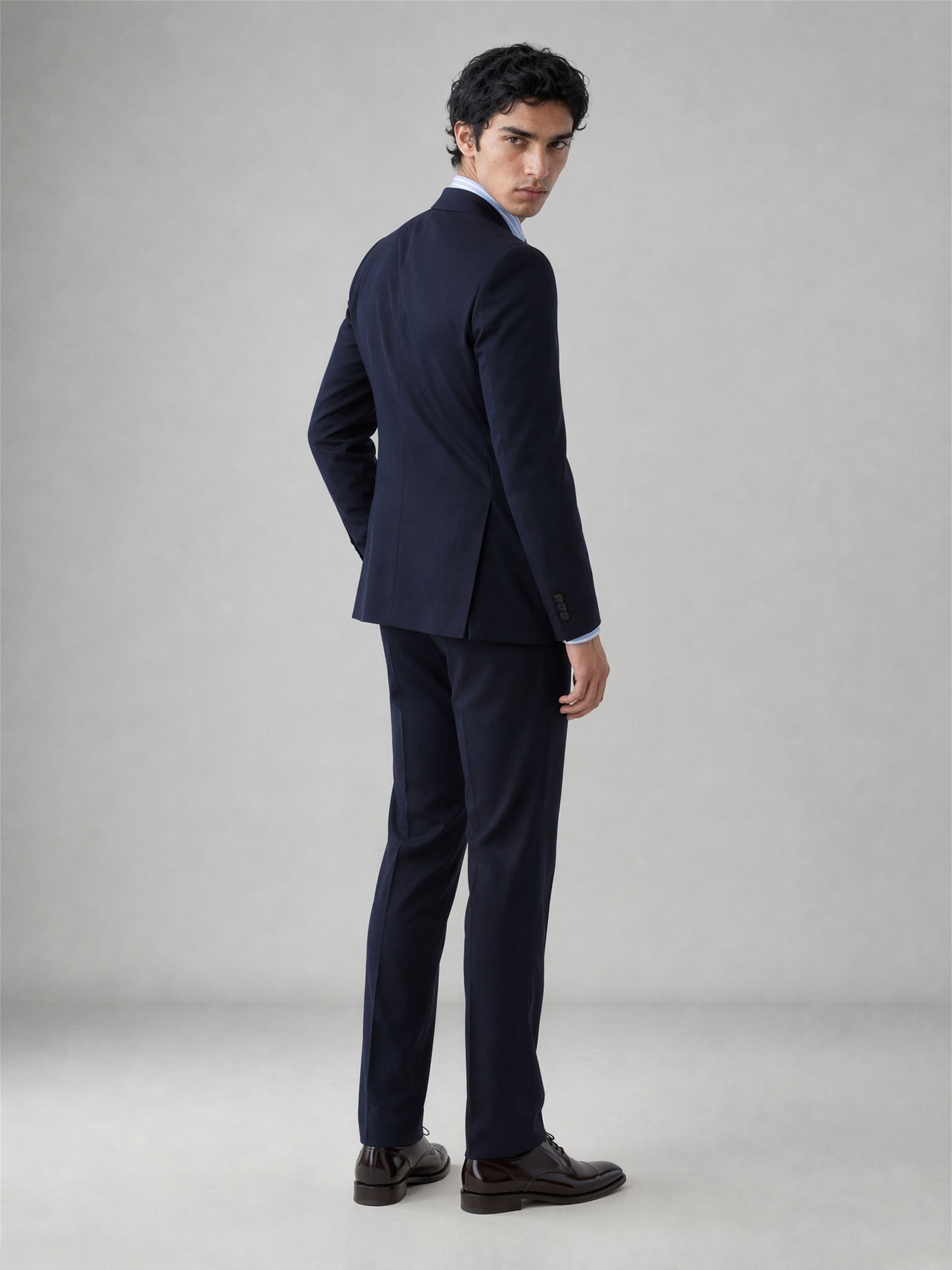 Savile GA0076 midnight navy wool suit – full body front view, arms crossed showing structured notch lapel silhouette and slim trouser drape