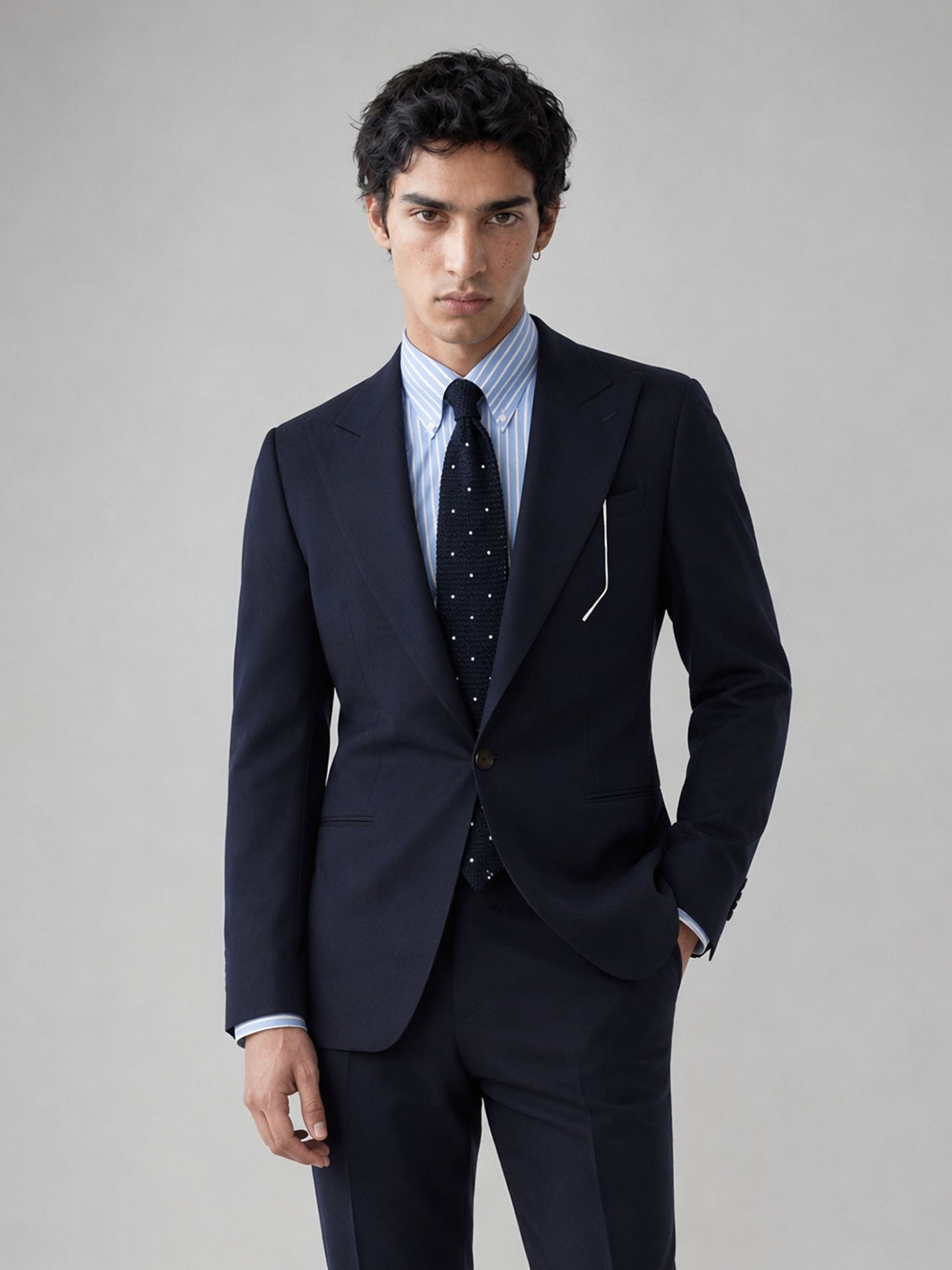 Savile GA0076 midnight navy wool 2-piece suit – full body three-quarter side pose, hand in pocket showing slim-fit silhouette and refined navy fabric