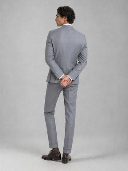 Savile GA0078 mid grey double-breasted suit – back view, hands clasped behind showing center vent, structured peak lapel shoulders and turn-up trouser drape