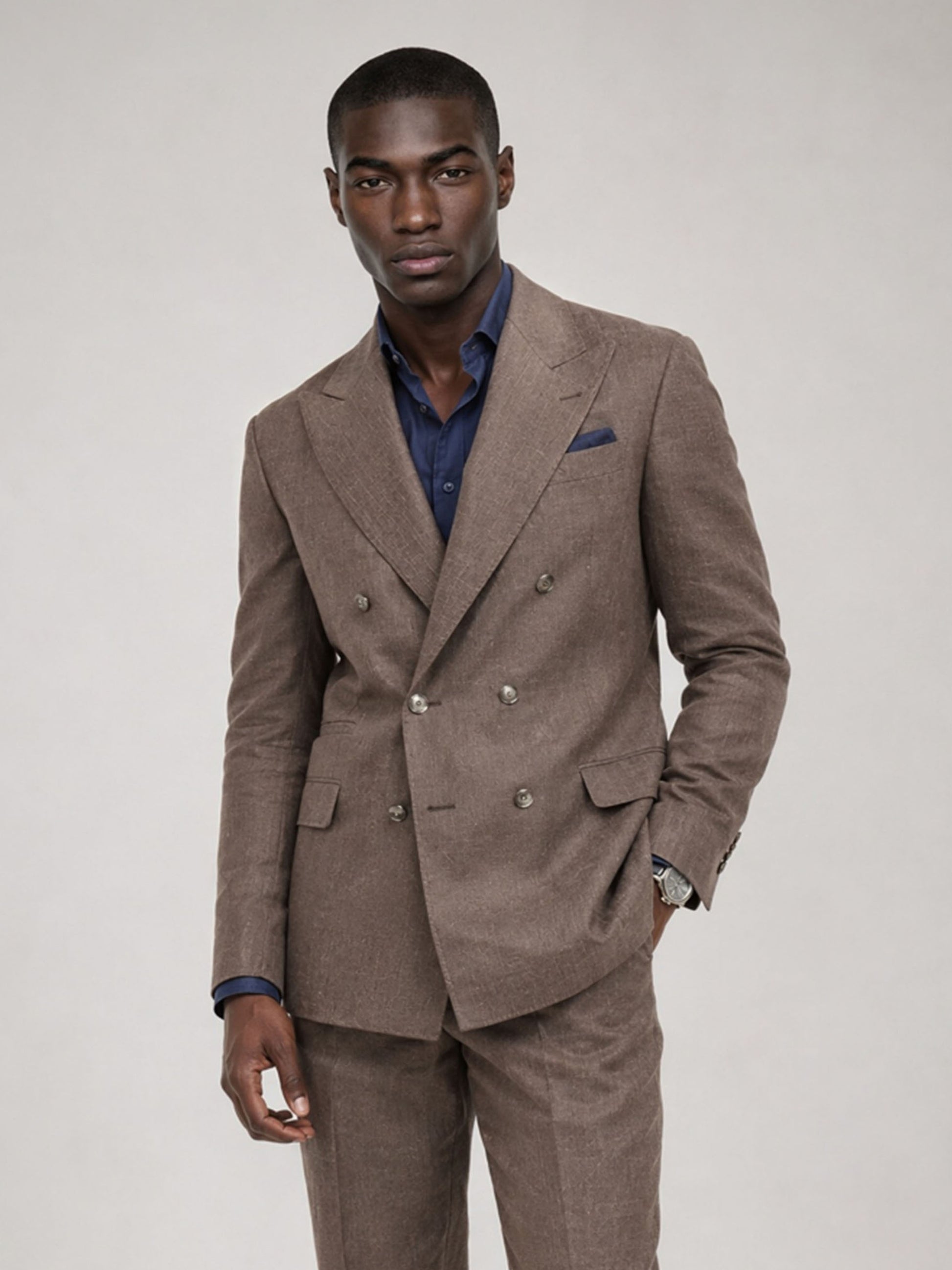 Savile GA0079 mocha brown linen double-breasted suit – full body front view, arms crossed with dark brown suede loafers and navy open-collar shirt
