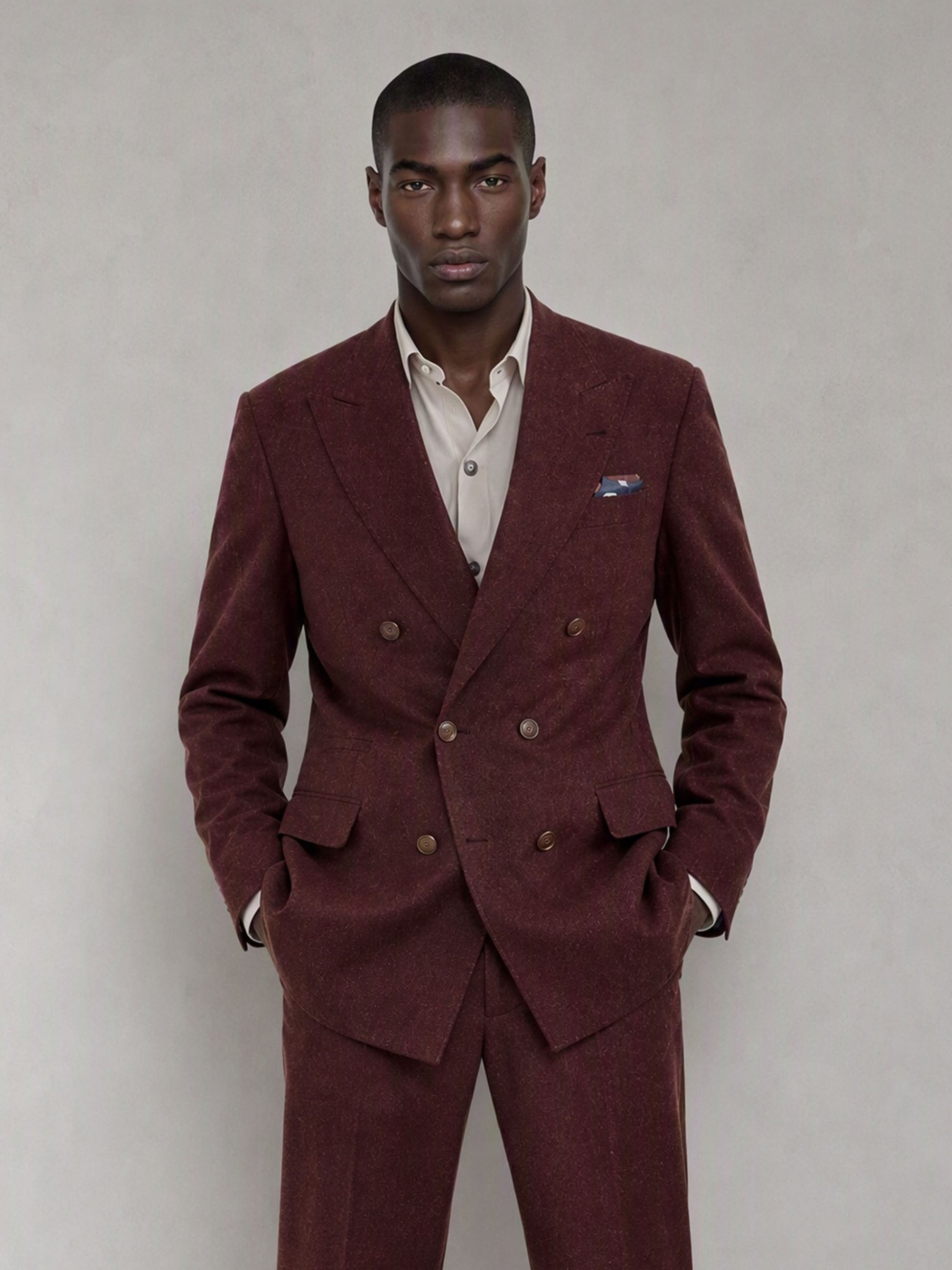Savile GA0080 burgundy double-breasted suit – full body front view, hands in pockets with brown suede chelsea boots and cream open-collar shirt