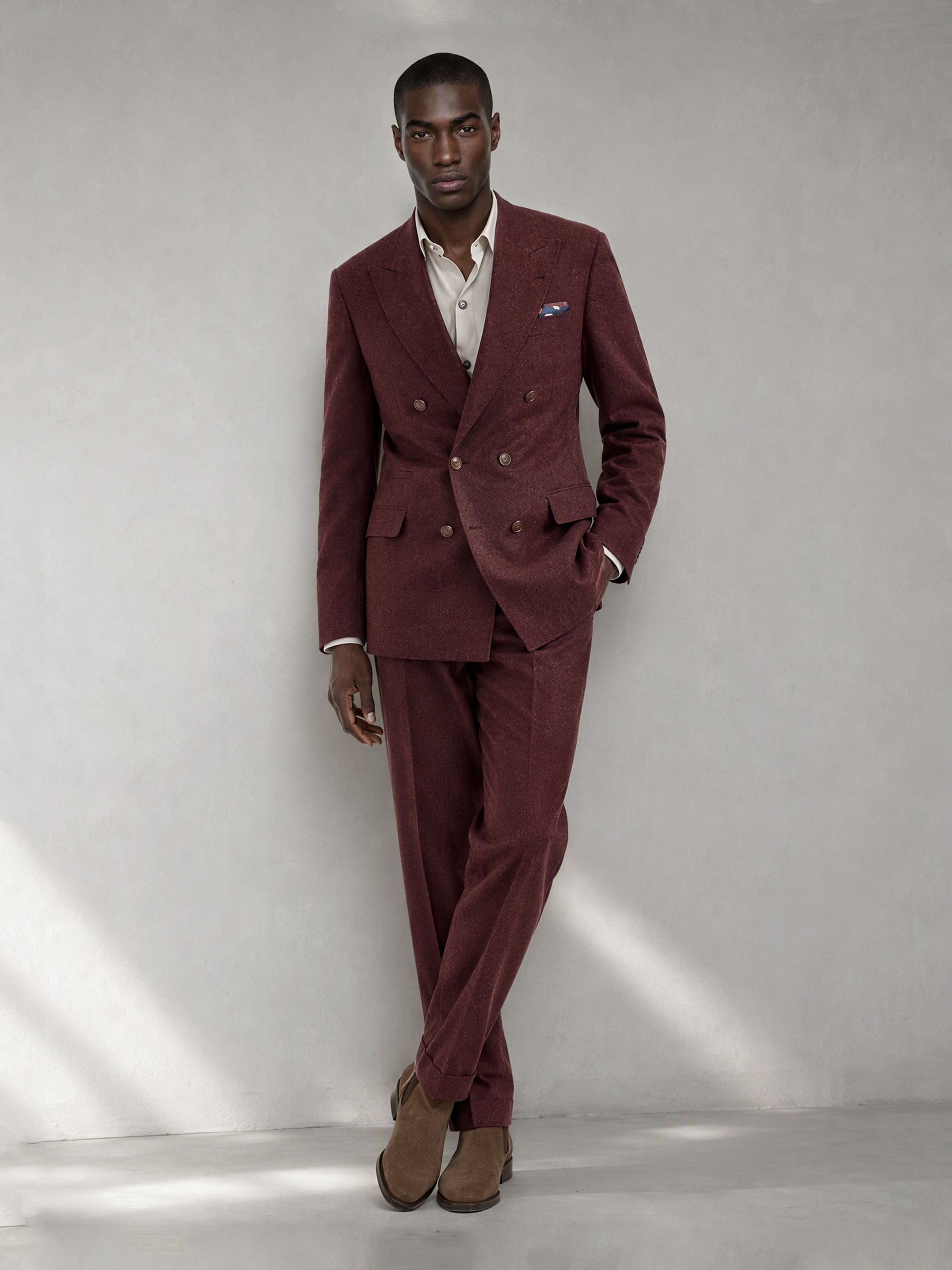 Savile GA0080 burgundy wool 2-piece suit set – full body front view, relaxed lean against wall showing slim silhouette and peak lapel detail