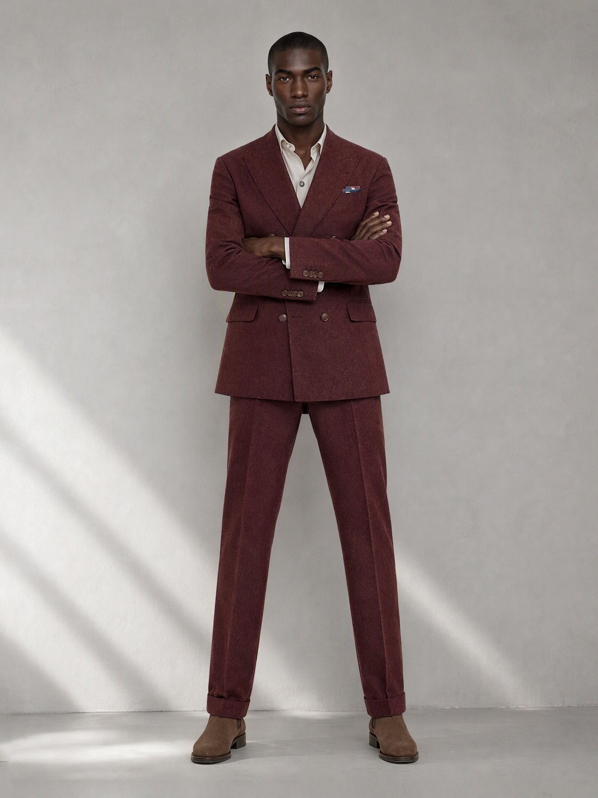 Savile GA0080 burgundy double-breasted suit – full body front view, arms crossed showing structured peak lapel silhouette and slim trouser drape