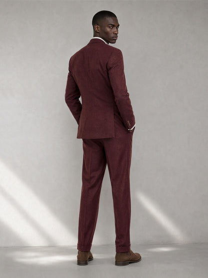 Savile GA0080 burgundy double-breasted suit – back three-quarter view, model looking over shoulder showing center vent and slim trouser silhouette