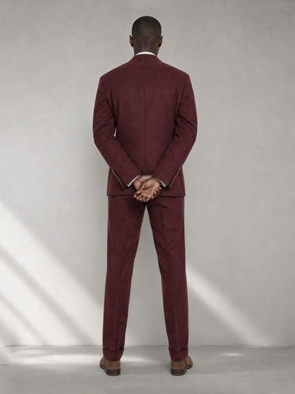 Savile GA0080 burgundy wool suit set – back view, hands clasped behind showing center vent, structured peak lapel shoulders and clean slim trouser drape