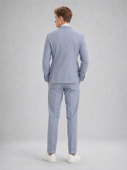 Savile GA0082 powder blue linen 2-piece suit – full body front view, arms crossed showing structured peak lapel silhouette and slim turn-up trouser drape