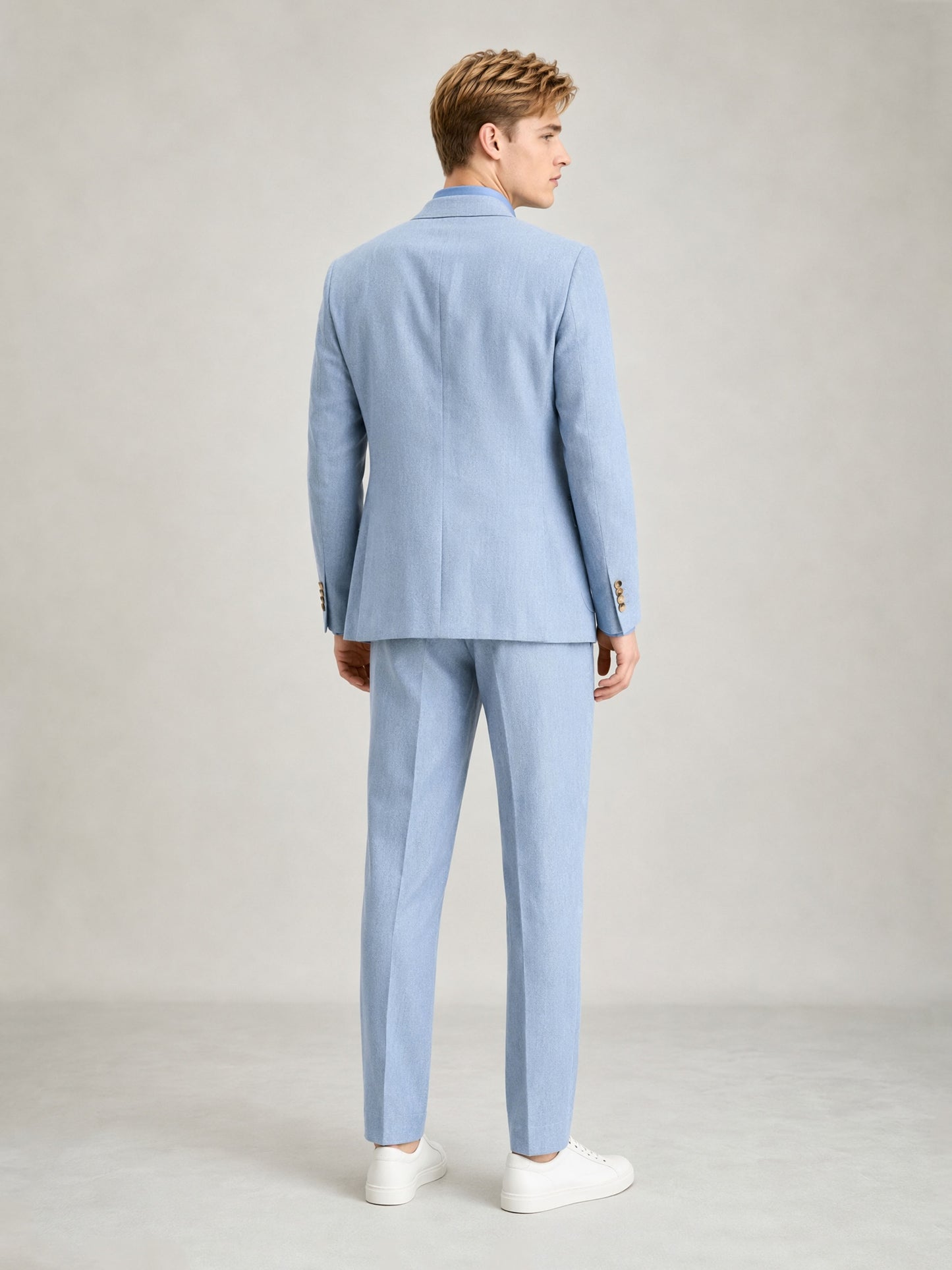 Savile GA0084 ice blue linen suit – full body front view, arms crossed leaning against wall showing Italian drape and slim trouser silhouette
