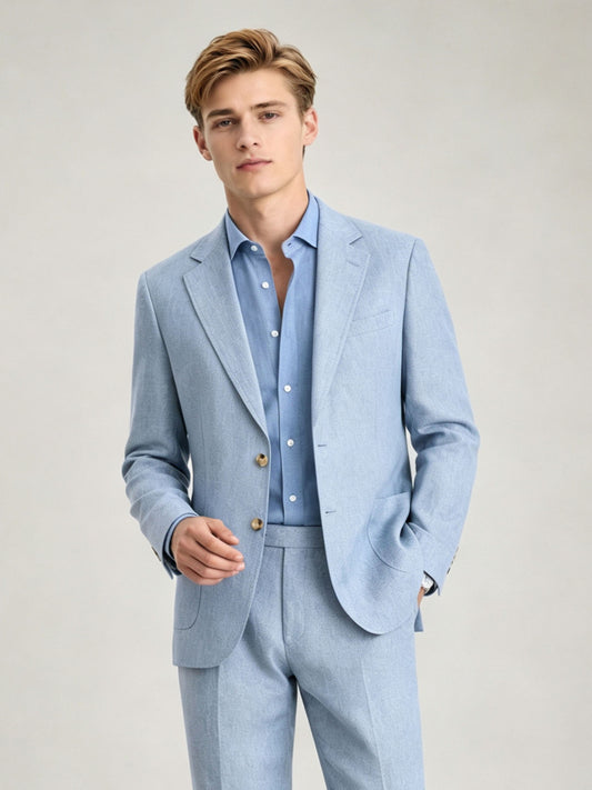 Savile GA0084 ice blue linen 2-piece suit – full body three-quarter side pose, hands in pockets showing complete Italian tailoring silhouette and gold button cuffs