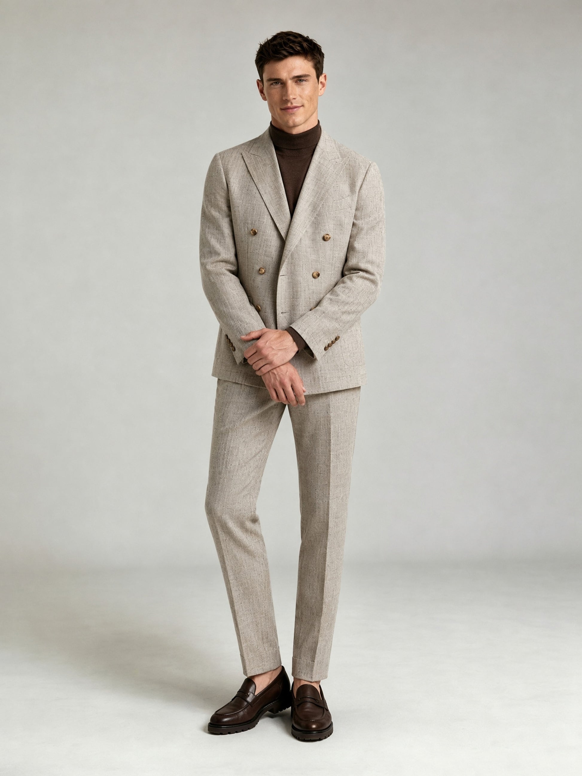 Savile GA0086 oatmeal greige double-breasted suit set – back three-quarter view, model looking over shoulder showing center vent and slim trouser silhouette