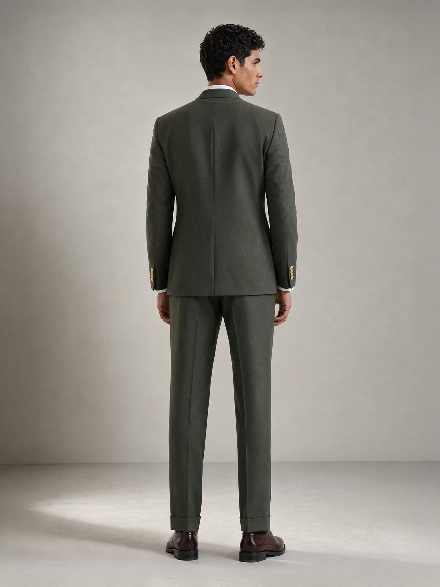 Savile GA0087 olive green double-breasted suit – full body front view, hand in pocket showing Italian drape, peak lapel profile and turn-up trouser cuffs
