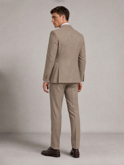 Savile GA0091 warm sand check suit – full body front view, hand touching lapel showing waistcoat layering, notch lapel profile and slim trouser silhouette