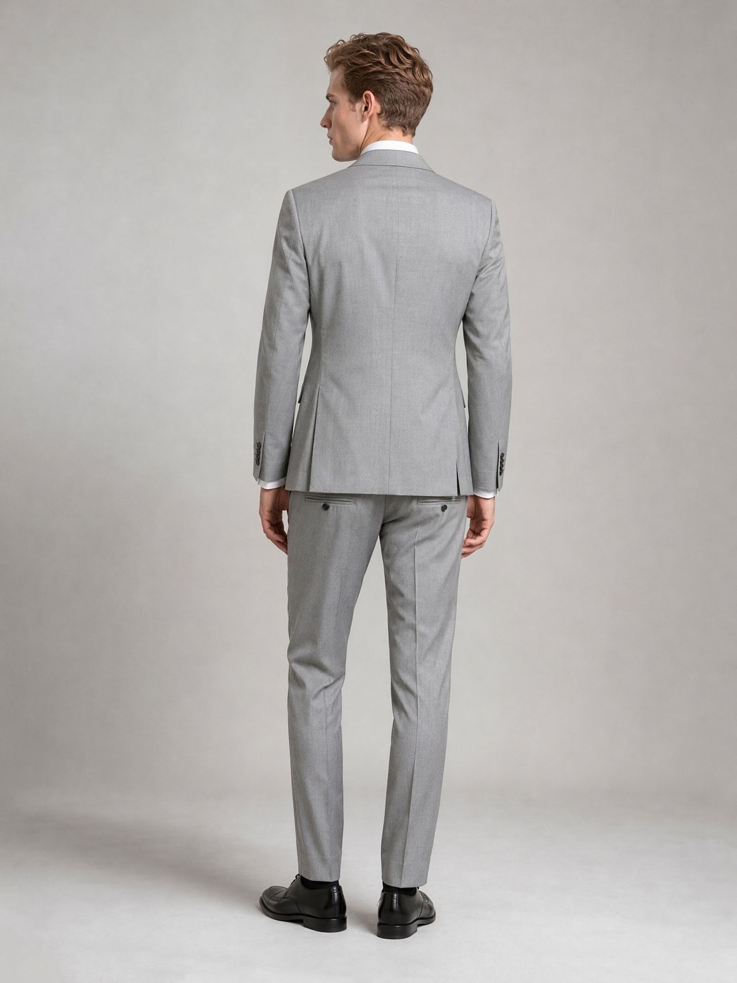 Savile GA0092 light grey wool suit set – back view showing side vents, structured notch lapel shoulders and slim trouser drape with black oxfords