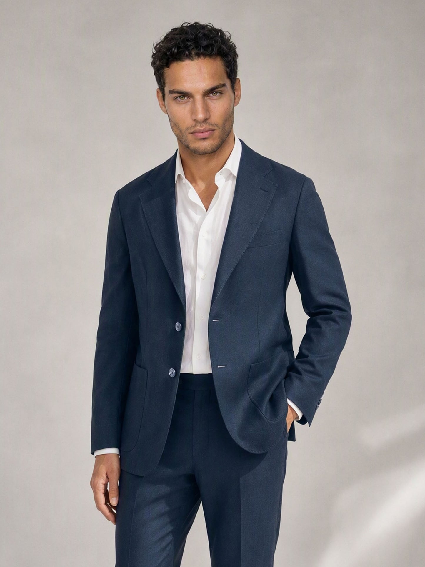Savile navy linen suit – full-length front view, hand in pocket