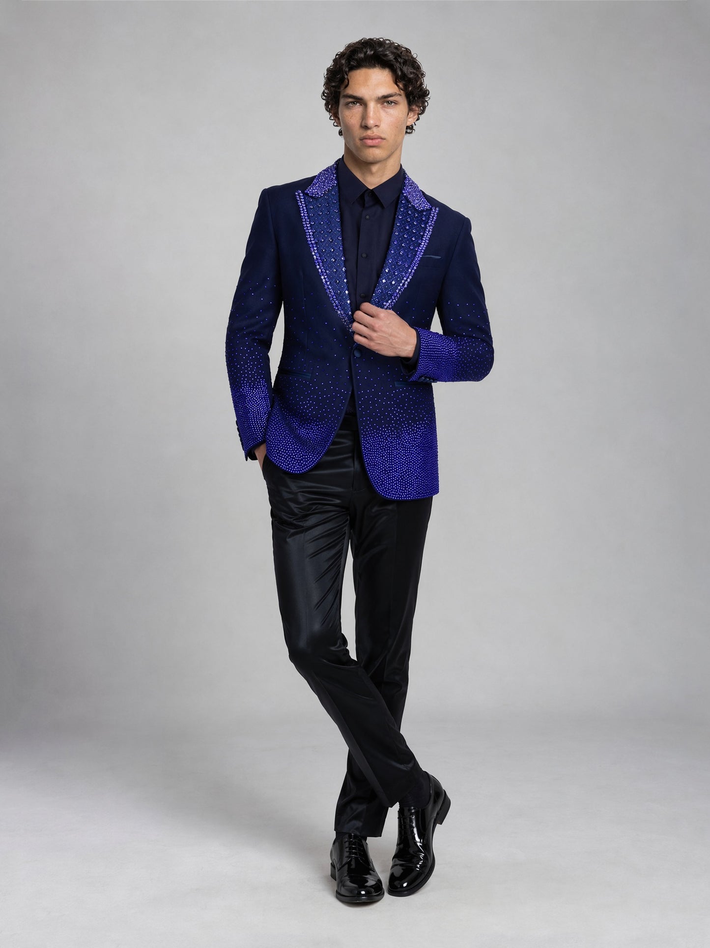 Savile royal blue rhinestone suit – full-length front view, hand on lapel