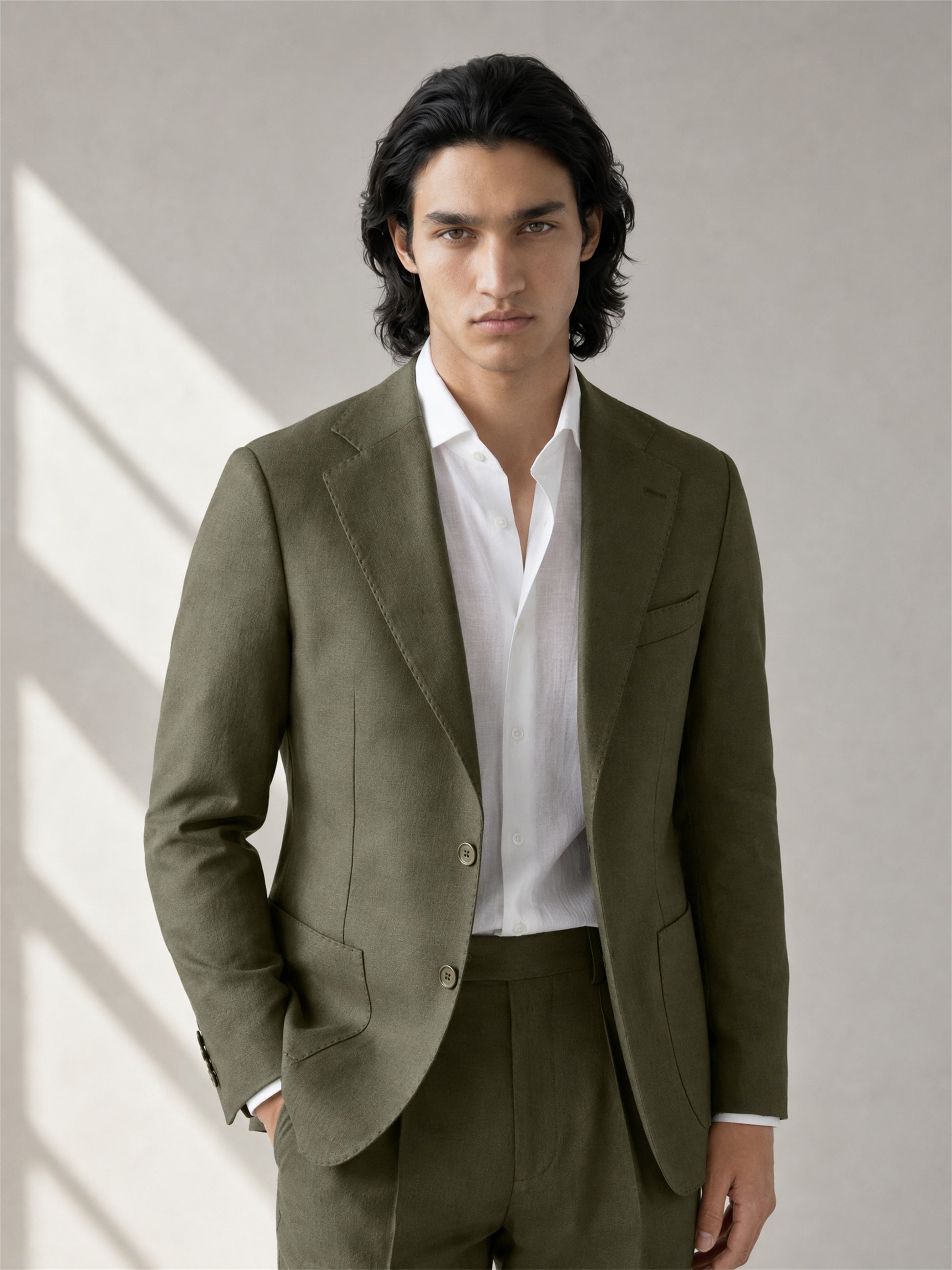 Savile olive green linen suit – full-length walking shot, natural light