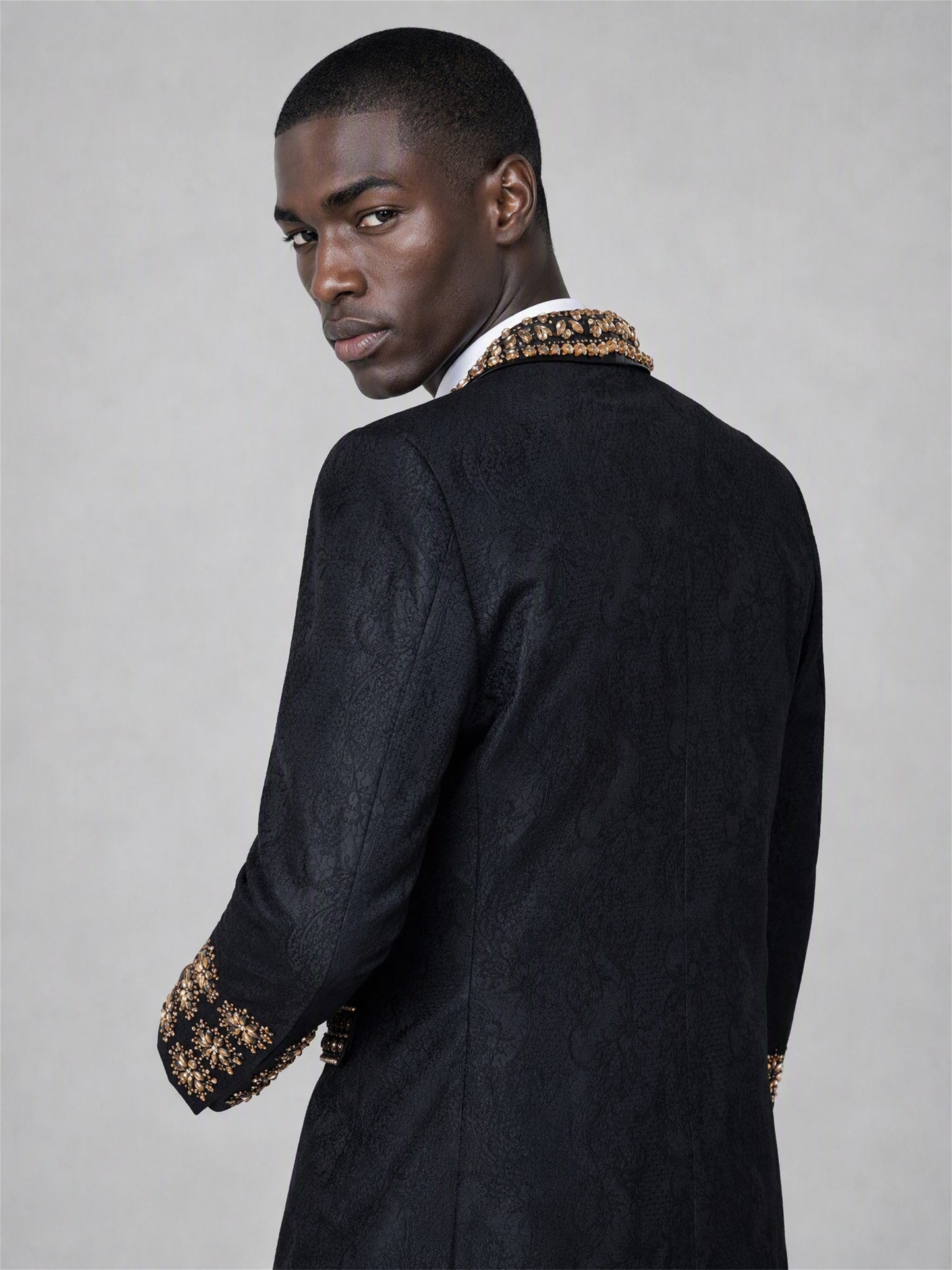 Savile black jacquard gold crystal suit – back view showing gold embroidered cuffs and jacquard texture