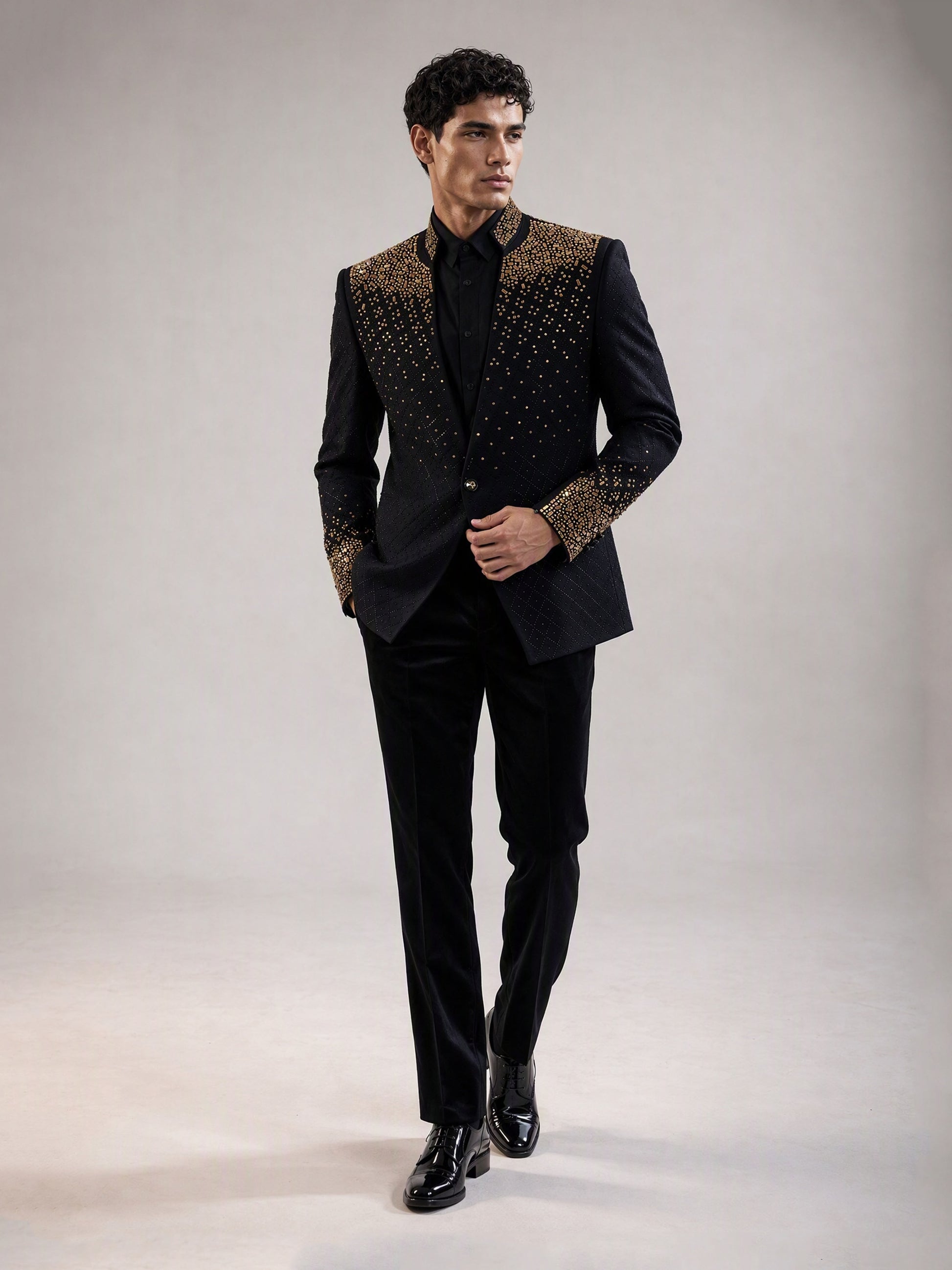 Savile black gold gradient crystal suit – full-length front view, hands in pockets showing shoulder-to-chest crystal cascade