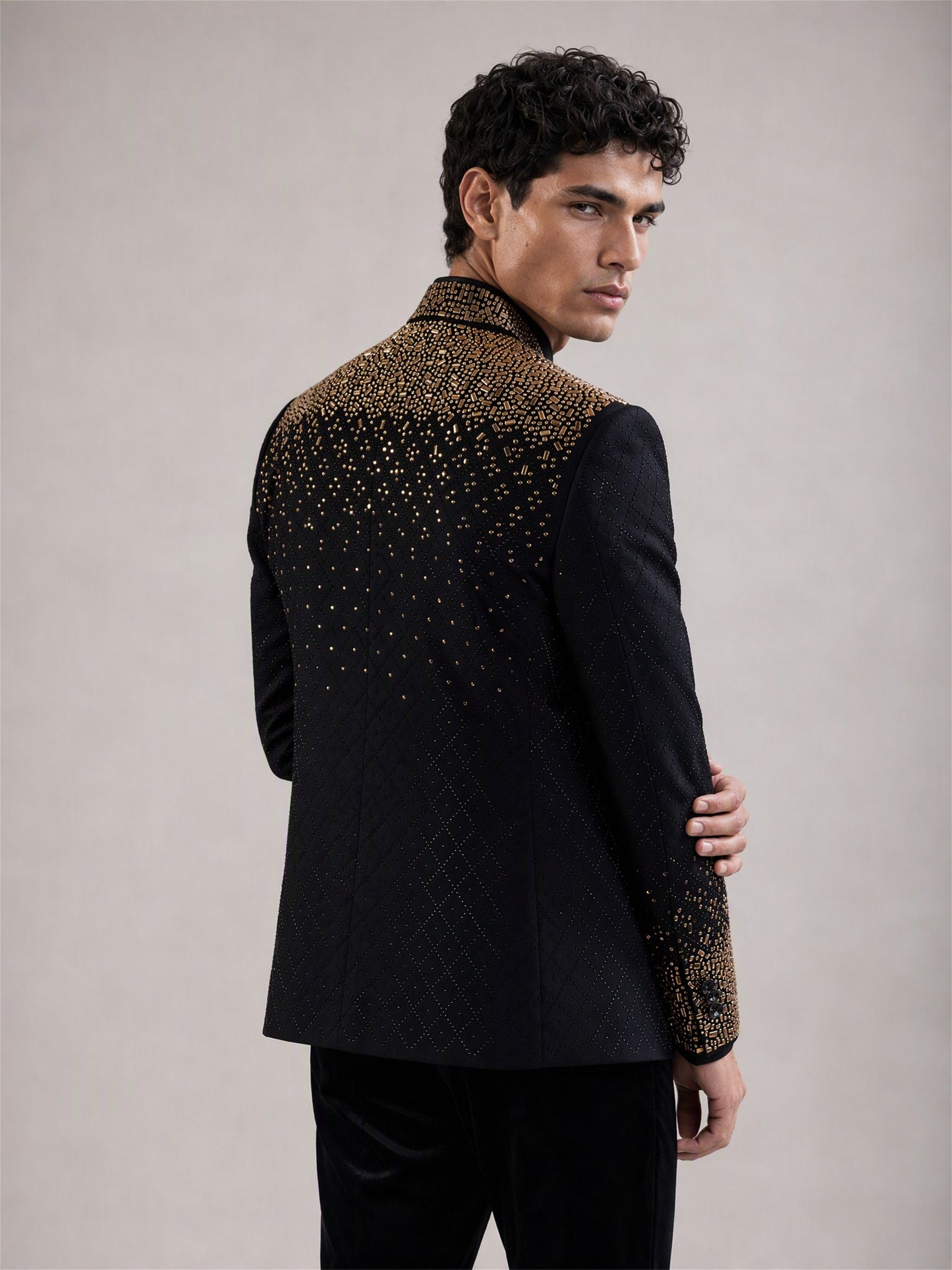 Savile black gold gradient crystal suit – back view showing gold gradient crystal cascade across upper back and shoulders