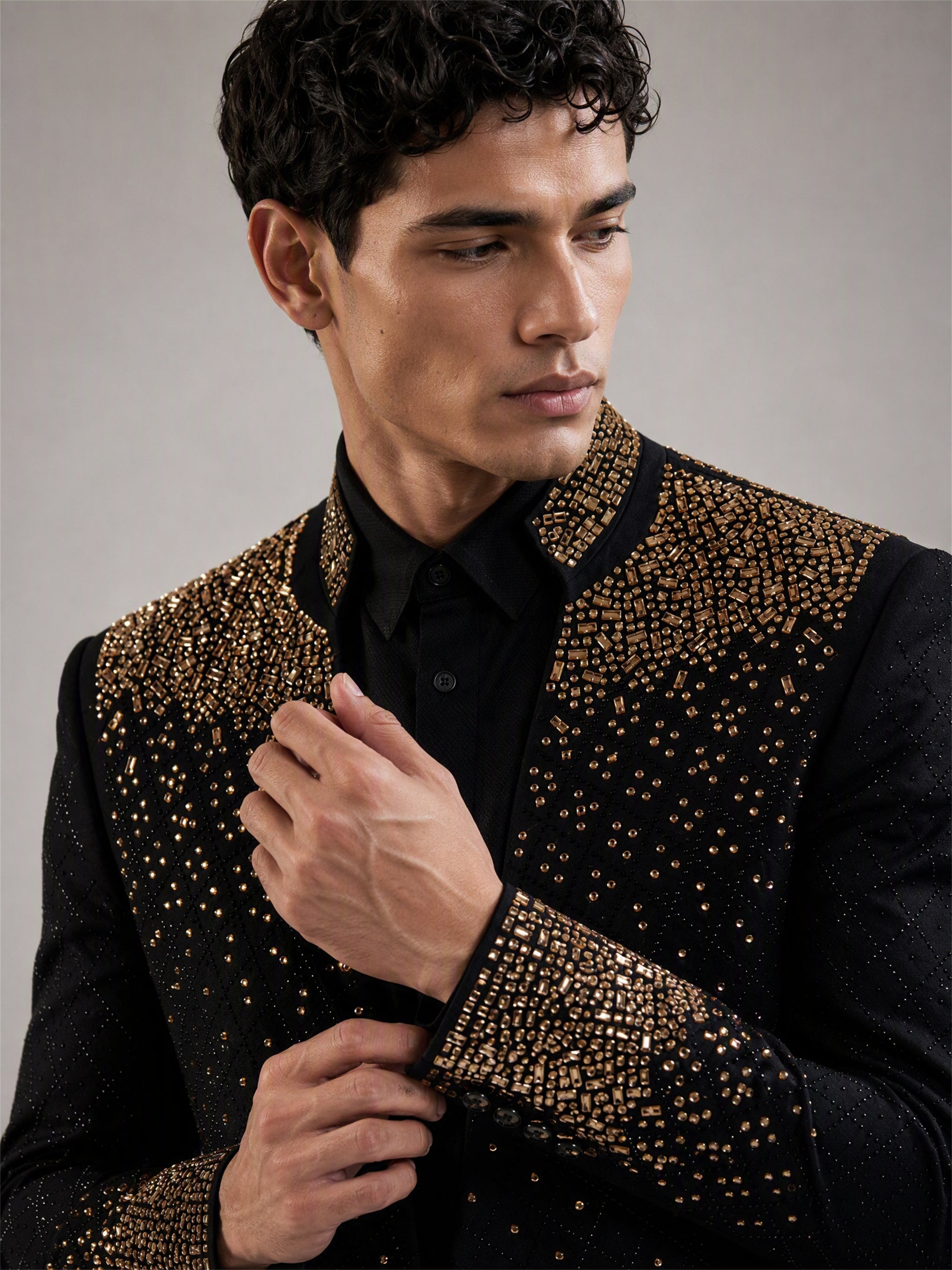 Savile black gold gradient crystal suit – close-up upper body detail, mixed-cut gold crystals on cuffs and lapel trim