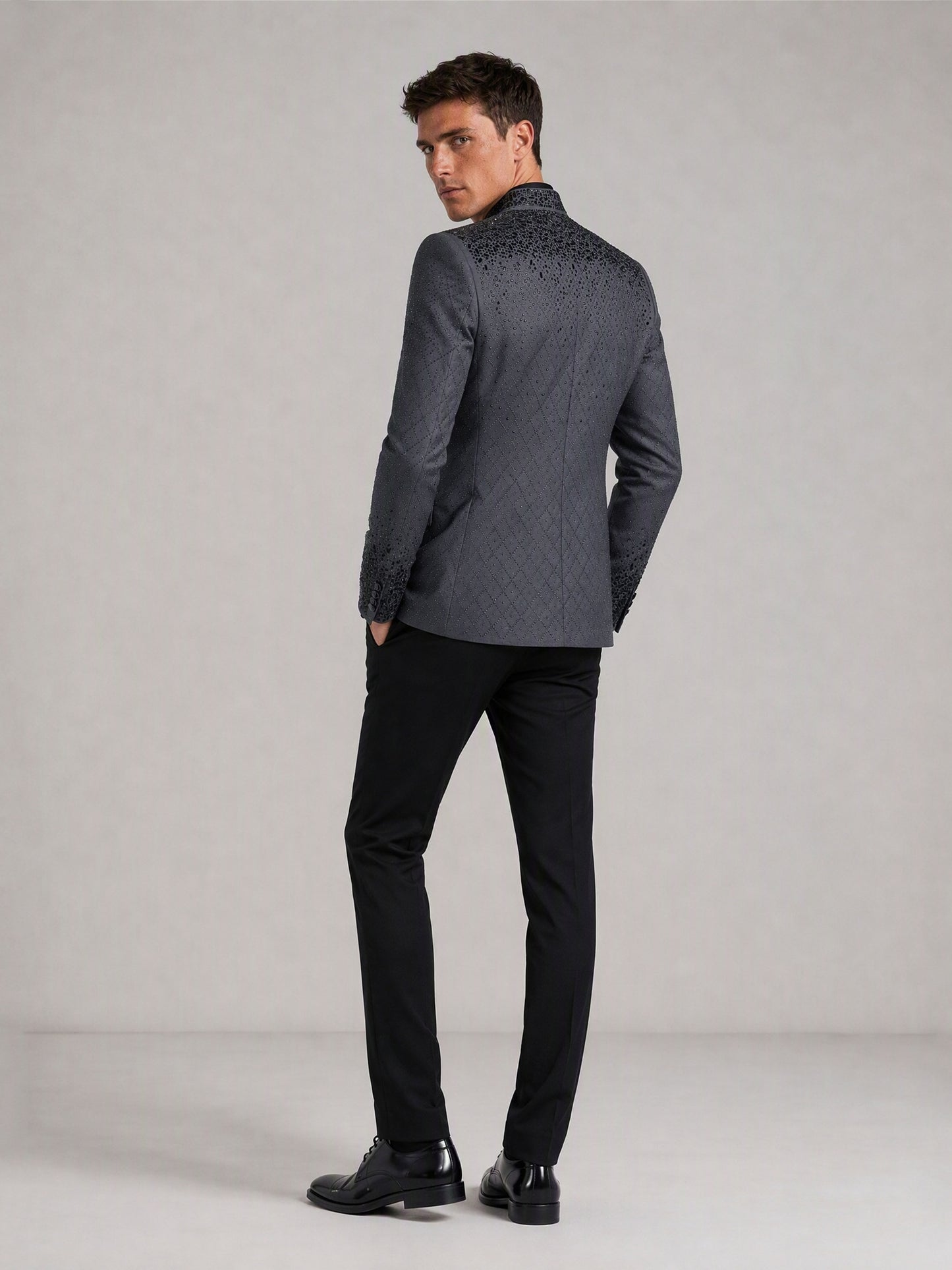 Savile charcoal plaid jacquard black crystal suit – close-up upper body, jet-black mixed-cut crystals on shoulder and collar