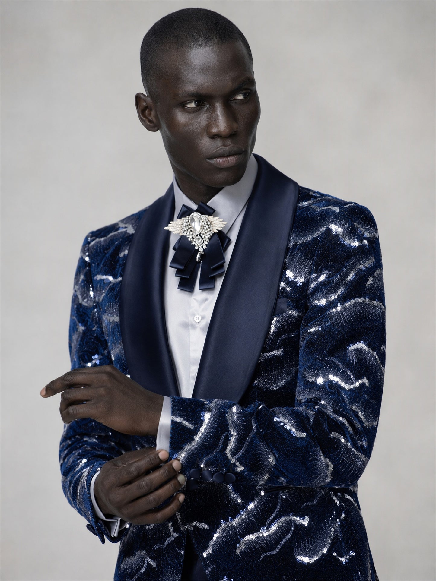 Savile navy blue velvet sequin suit – full-length walking shot, three-quarter view showing sequin texture in motion