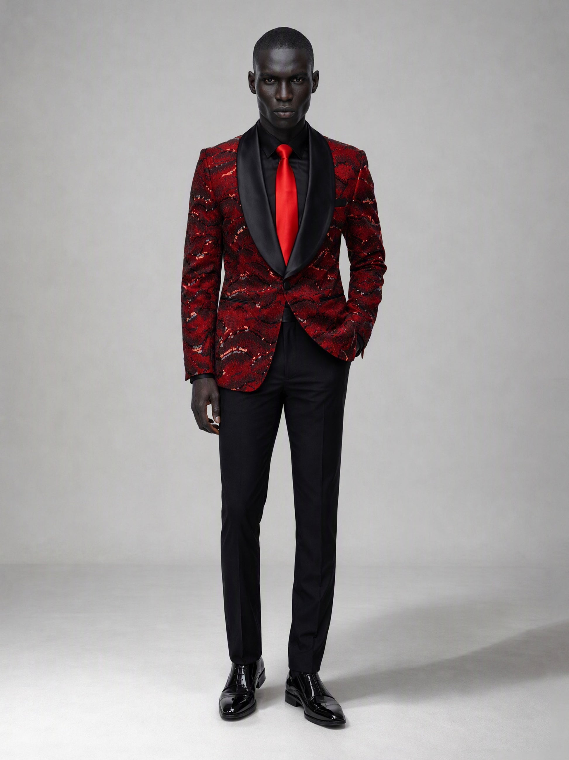 Savile red velvet sequin suit – full-length front view, hand in pocket showing red-on-black contrast