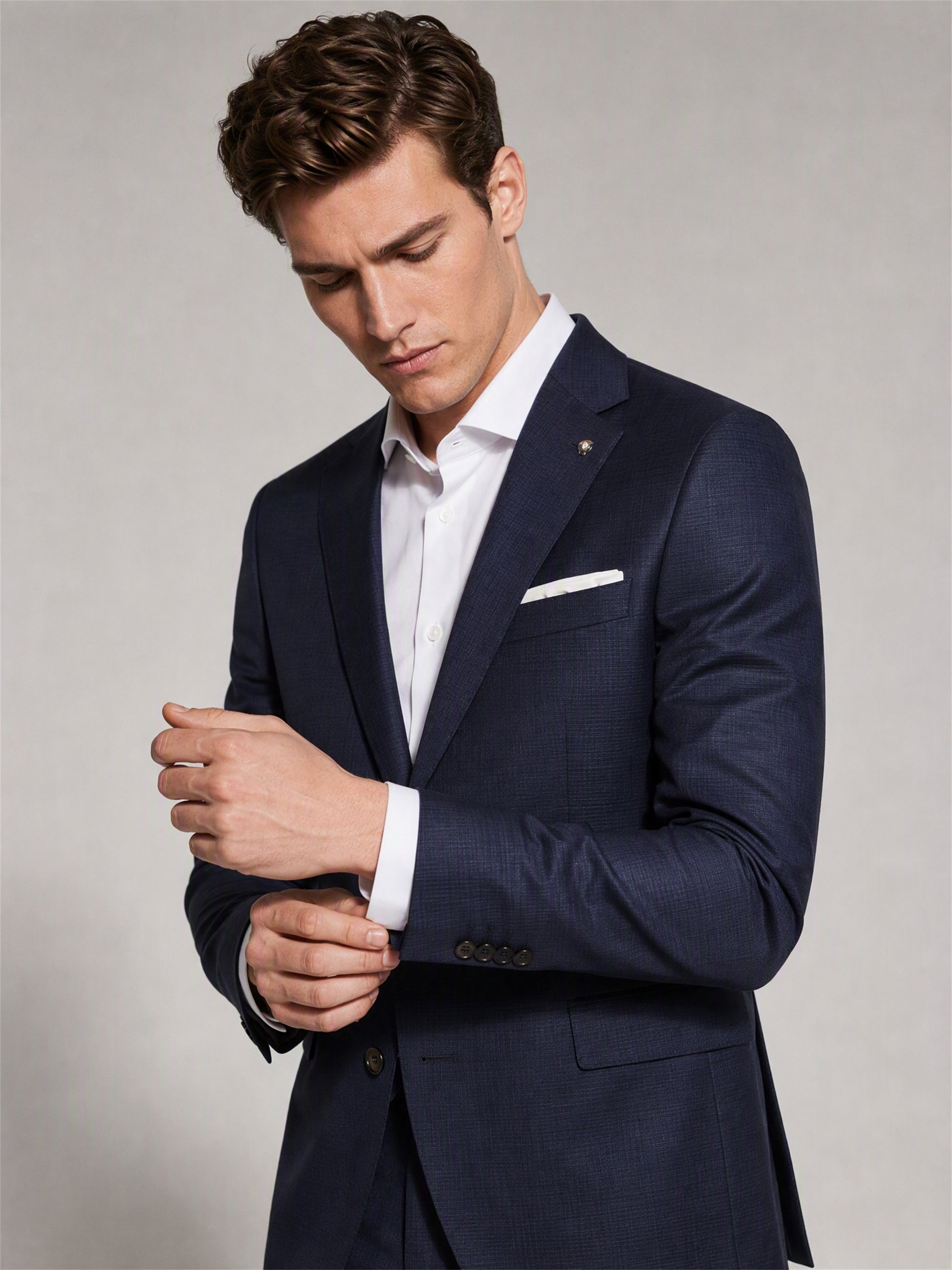 Savile navy blue business suit – full-length front view, open-collar white shirt and brown monk-strap shoes