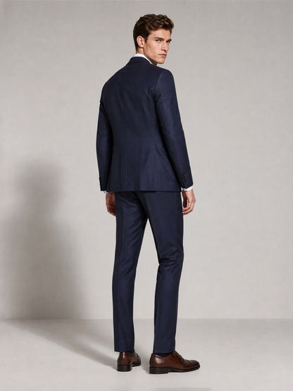 Savile navy blue business suit – close-up upper body, adjusting cuff showing notch lapel and pocket square detail